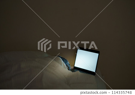 Young woman spending her time in bed 114335748