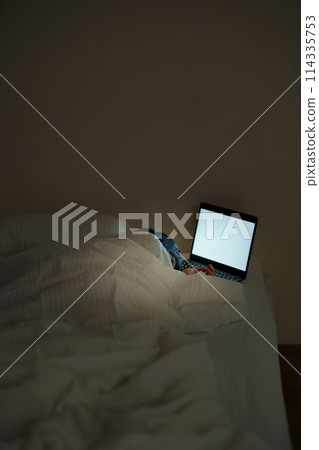 Young woman spending her time in bed Young woman spending her time in bed 114335753