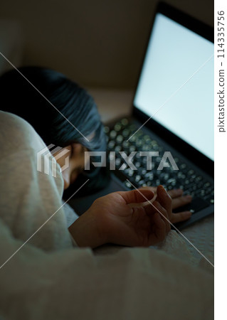 Young woman spending her time in bed Young woman spending her time in bed 114335756