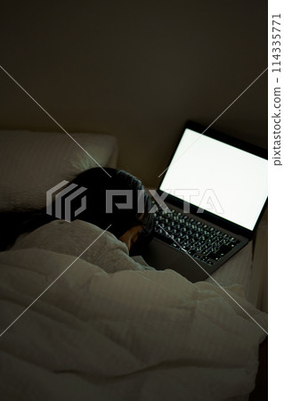 Young woman spending her time in bed 114335771