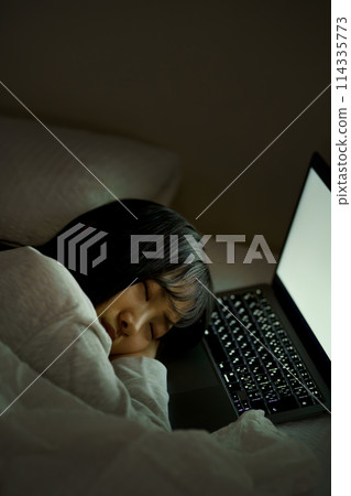 Young woman spending her time in bed Young woman spending her time in bed 114335773