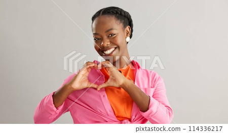 Happy, black woman and heart hands with love for care, support or romance on a gray studio background. Portrait of African female person with smile, like emoji or shape for romantic gesture on mockup Happy, black woman and heart hands with love for care, support or romance on a gray studio background. Portrait of African female person with smile, like emoji or shape for romantic gesture on mockup 114336217