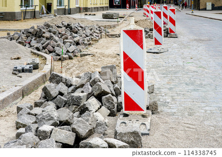Street paving with historical hammered granite paving stones, city street surface restoration Street paving with historical hammered granite paving stones, city street surface restoration 114338745
