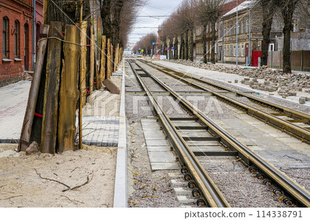 Street reconstruction, tree trunks with board protectors, newly replaced tram tracks and pavement 114338791
