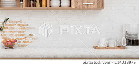 A display space on a kitchen tabletop features a coffee maker machine against the white brick wall. 114338972