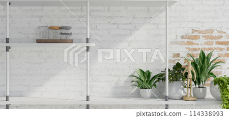 A minimal rustic white brick wall with a modern wall shelf, home decor, and houseplant in pots. A minimal rustic white brick wall with a modern wall shelf, home decor, and houseplant in pots. 114338993