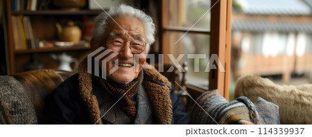 Cheerful korean elderly man in glasses relaxing at home 114339937