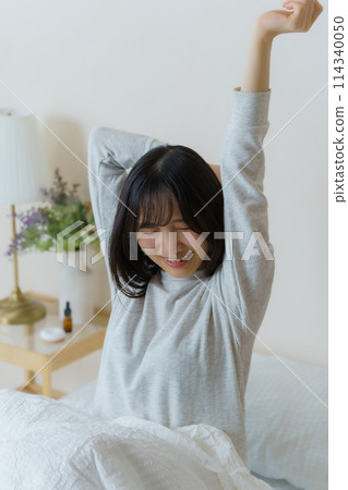 A young woman waking up refreshed in the morning 114340050