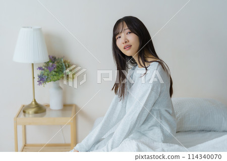A young woman waking up refreshed in the morning A young woman waking up refreshed in the morning 114340070