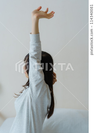 A young woman waking up refreshed in the morning A young woman waking up refreshed in the morning 114340081