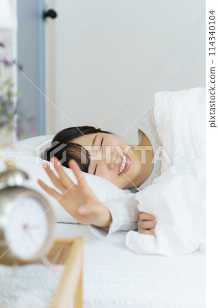 A young woman waking up refreshed in the morning A young woman waking up refreshed in the morning 114340104