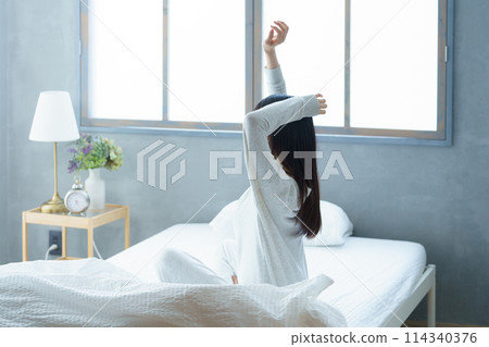 A young woman waking up refreshed in the morning 114340376