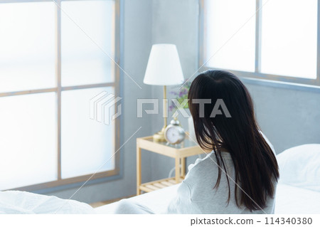 A young woman waking up refreshed in the morning A young woman waking up refreshed in the morning 114340380