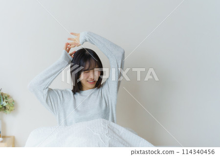 A young woman waking up refreshed in the morning 114340456