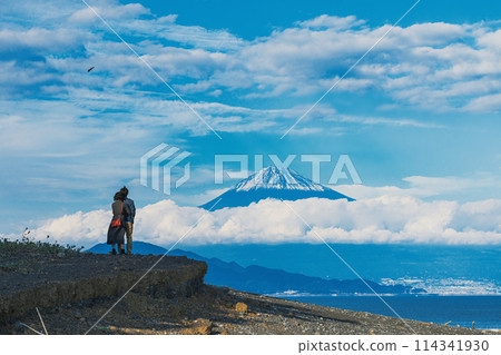 Couple looking at Mt. Fuji from the beach Couple looking at Mt. Fuji from the beach 114341930