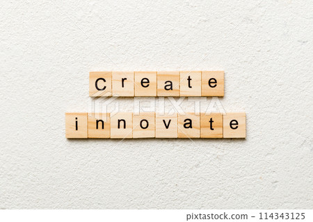 Create innovate word written on wood block. Create innovate text on cement table for your desing, Top view concept 114343125