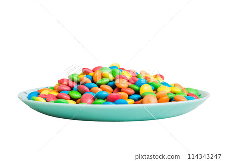 Multicolored candies in a bowl on a colored background. birthday and holiday concept. Top view with copy space Multicolored candies in a bowl on a colored background. birthday and holiday concept. Top view with copy space 114343247