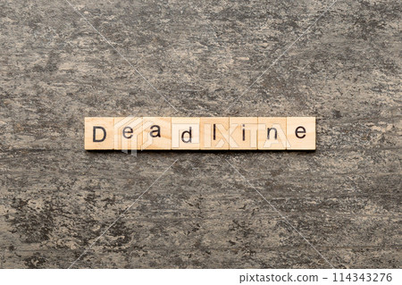 DEADLINE word written on wood block. DEADLINE text on cement table for your desing, concept 114343276