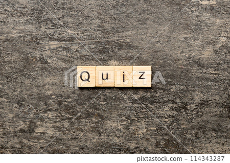 Quiz word written on wood block. Quiz text on cement table for your desing, Top view concept 114343287