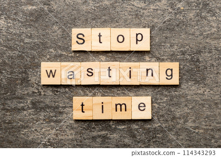 Stop wasting time word written on wood block. Stop wasting time text on cement table for your desing, Top view concept 114343293