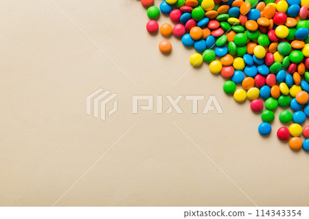Mixed collection of colorful candy, on colored background. Flat lay, top view. frame of colorful chocolate coated candy 114343354