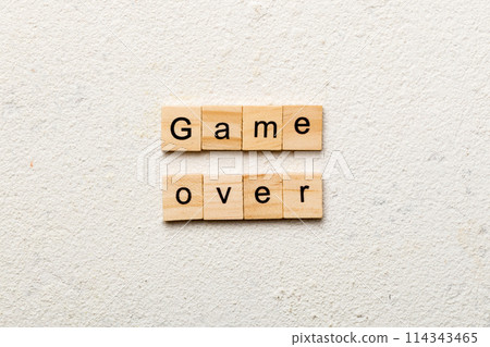 game over word written on wood block. game over text on table, concept 114343465