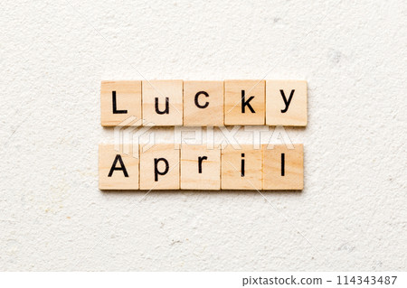 lucky april word written on wood block. Happy april text on table, concept 114343487