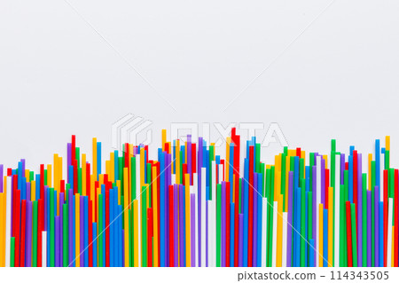 Heap of colorful plastic drinking straws on Colored background, flat lay. Copy Space for text 114343505