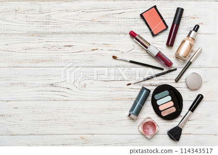 Professional makeup tools. Top view. Flat lay. Beauty, decorative cosmetics. Makeup brushes set and color eyeshadow palette on table background. Minimalistic style Professional makeup tools. Top view. Flat lay. Beauty, decorative cosmetics. Makeup brushes set and color eyeshadow palette on table background. Minimalistic style 114343517