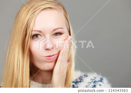 Young teenager woman thinking with hand on cheek 114343563
