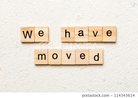 we have moved word written on wood block. we have moved text on cement table for your desing, concept we have moved word written on wood block. we have moved text on cement table for your desing, concept 114343614