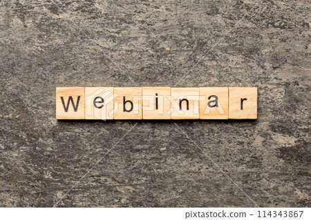 WEBINAR word written on wood block. WEBINAR text on cement table for your desing, concept 114343867