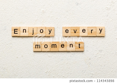 Enjoy Every Moment word written on wood block. Enjoy Every Moment text on cement table for your desing, concept Enjoy Every Moment word written on wood block. Enjoy Every Moment text on cement table for your desing, concept 114343898