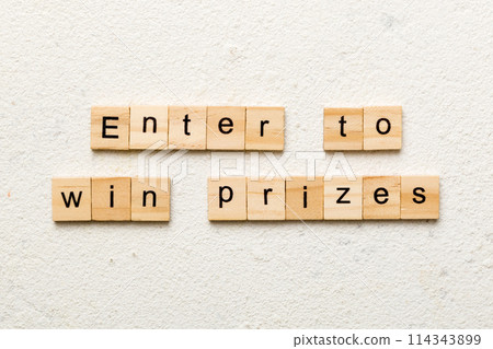 Enter to win prizes word written on wood block. Enter to win prizes text on cement table for your desing, Top view concept 114343899