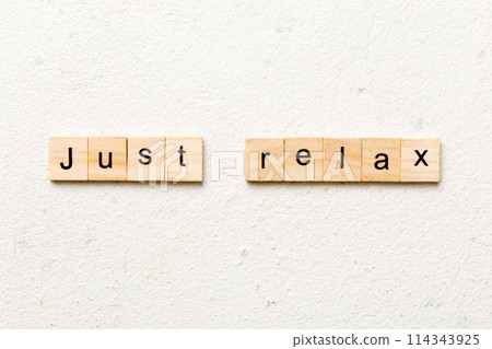 just relax word written on wood block. just relax text on table, concept 114343925
