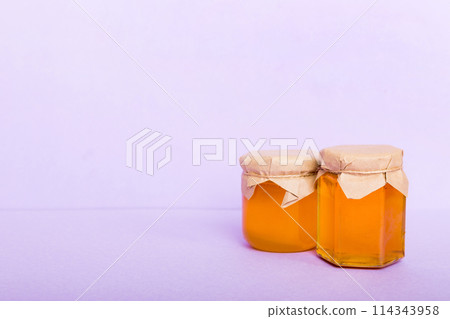 Glass jar full of honey on a colored background. Honey Bottle Mock-Up Glass jar full of honey on a colored background. Honey Bottle Mock-Up 114343958