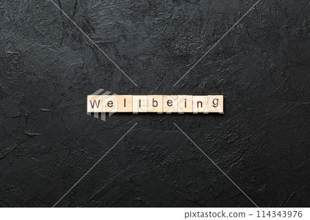 Wellbeing word written on wood block. Wellbeing text on cement table for your desing, concept Wellbeing word written on wood block. Wellbeing text on cement table for your desing, concept 114343976