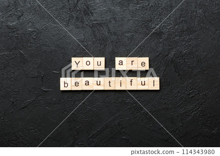 You are beautiful word written on wood block. You are beautiful text on cement table for your desing, Top view concept 114343980
