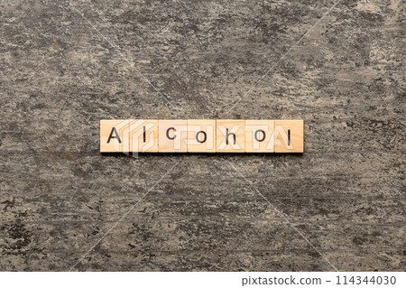 alcohol word written on wood block. alcohol text on table, concept alcohol word written on wood block. alcohol text on table, concept 114344030