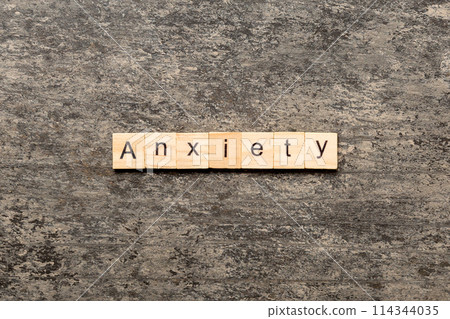 ANXIETY word written on wood block. ANXIETY text on table, concept ANXIETY word written on wood block. ANXIETY text on table, concept 114344035