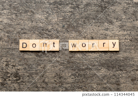Don't worry word written on wood block. Don't worry text on cement table for your desing, Top view concept Don't worry word written on wood block. Don't worry text on cement table for your desing, Top view concept 114344045