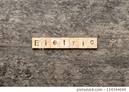 Electric word written on wood block. Electric text on cement table for your desing, concept 114344049