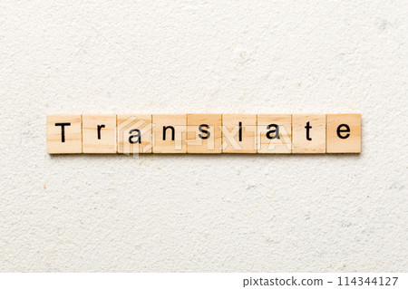 Translate word written on wood block. Translate text on cement table for your desing, concept Translate word written on wood block. Translate text on cement table for your desing, concept 114344127