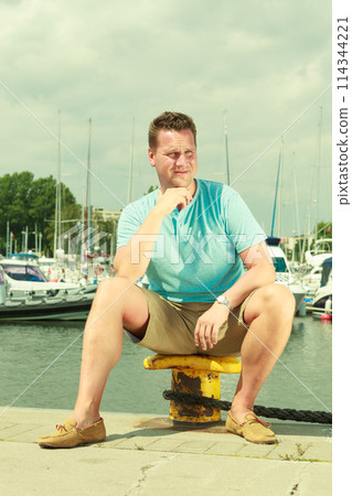Man walking on marina during summer Man walking on marina during summer 114344221