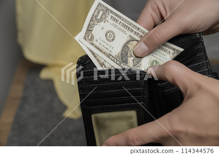 close-up of a hand counting paper money 114344576