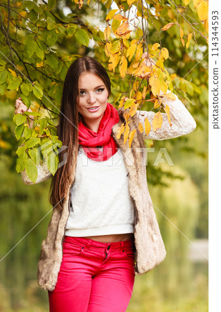 woman fashion girl relaxing walking in autumnal park woman fashion girl relaxing walking in autumnal park 114344593