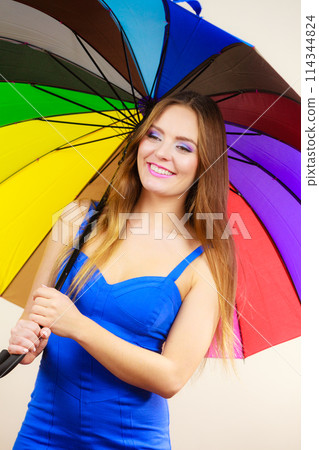 Woman in summer dress holds colorful umbrella 114344824