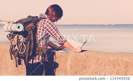 Man hiker with backpack tramping by seaside 114345038