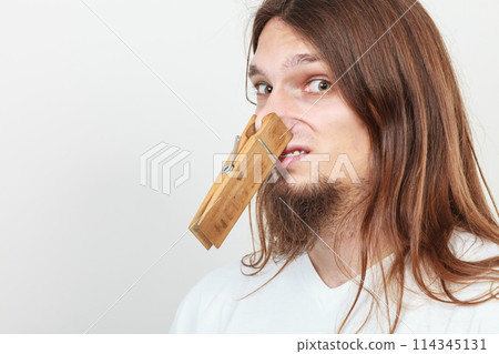 Man with clothespin on nose Man with clothespin on nose 114345131