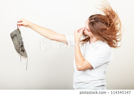 Man with stinky shoe 114345147